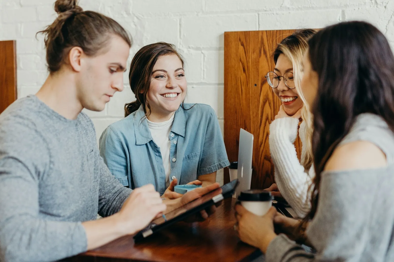 A recruiting team laughing together around a table